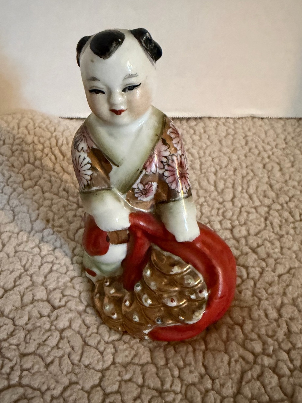 Vintage hand painted Chinese porcelain child holding bag of gifts, prosperity